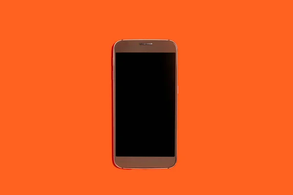 Smartphone su sfondo arancione — Foto Stock