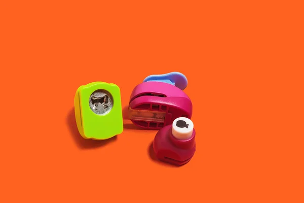 Hole punchers on an orange background — Stock Photo, Image