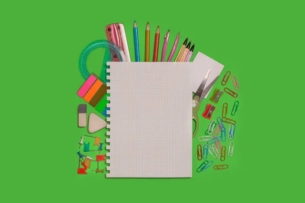Office supplies on a green surface — Stock Photo, Image