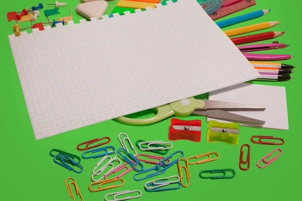 Different office supplies on a green surface — Stock Photo, Image