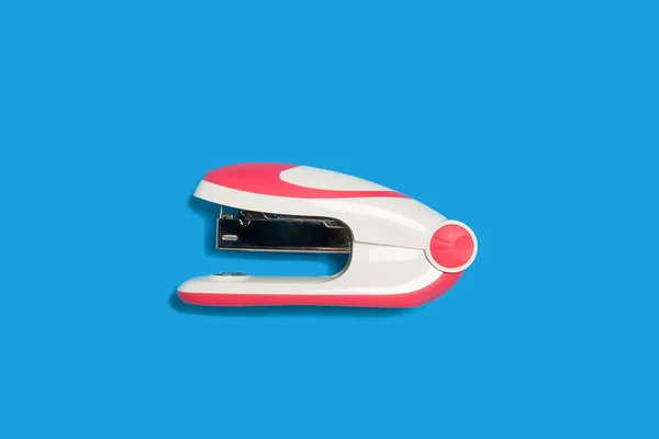 stapler on a blue background