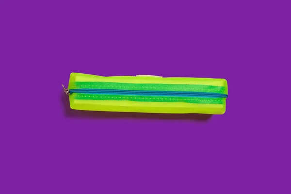 Желтый пенал на фиолетовой поверхности — стоковое фото