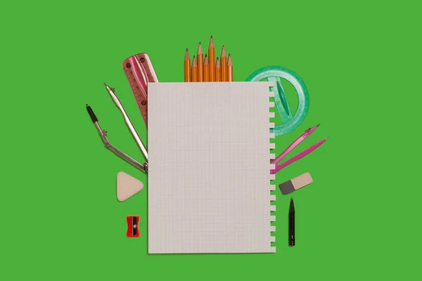 Various office supplies surrounding a sheet of paper — Stock Photo, Image