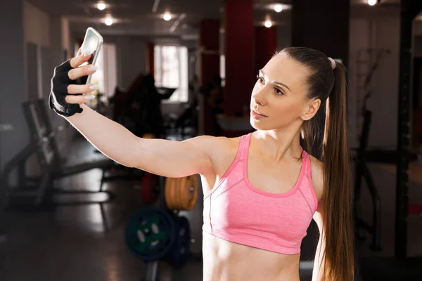 Tjej att göra selfie foto på gymmet — Stockfoto