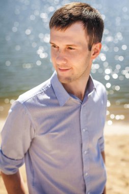 Göl kenarında oturan genç çocuk