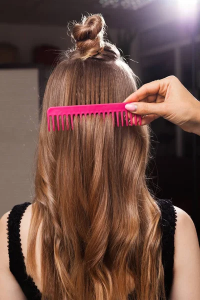 hairdresser brushing hair of a client