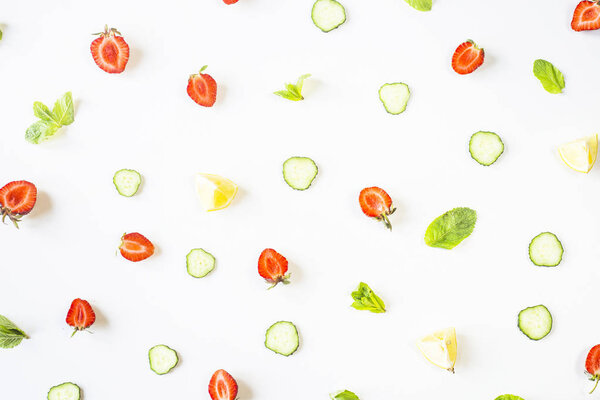 Strawberries, lemon, cucumber and mint on white background scatter. Patten Detox Concept. Top view, flat lay