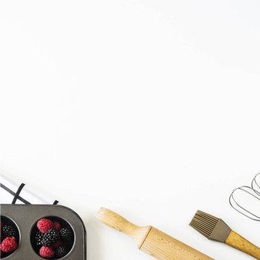 Ahududu ve böğürtlen için Wight'deki / arka plan için yemek - mutfak aksesuarları arasında üzerinde pişirme kek formunda haddeleme pin ve çırpma teli bir mikser çilek. Üstten görünüm, düz yatıyordu, kopya alanı