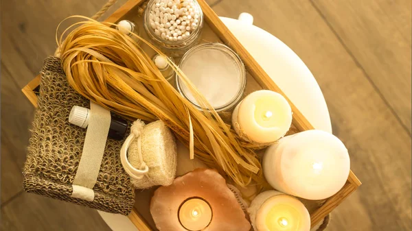 Ecological accessories for a spa in a home bathroom on a wooden tray with candles. Eco accessories. Top view, flat lay