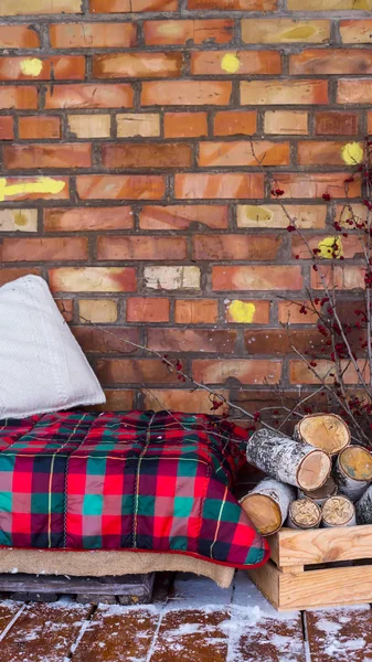 Una Pila Legno Betulla Vicino Divano Con Una Coperta Rossa — Foto Stock