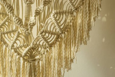 Macrame panel decor made of cotton cord. Wicker hand made modern Scandinavian interior decoration clipart