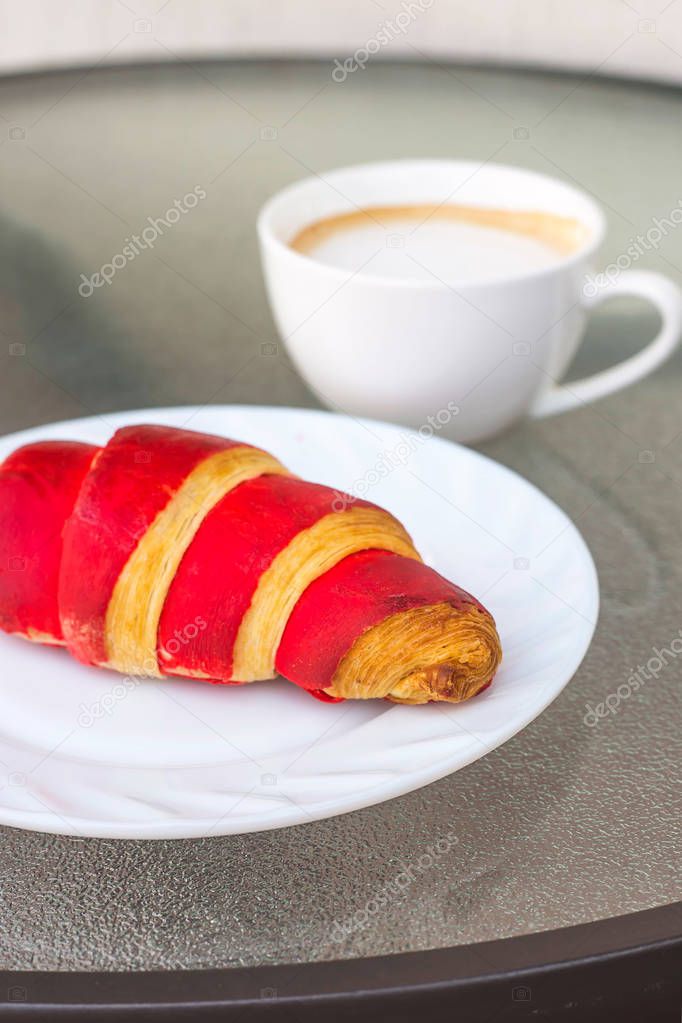 Traditional French breakfast of coffee and fresh croissant