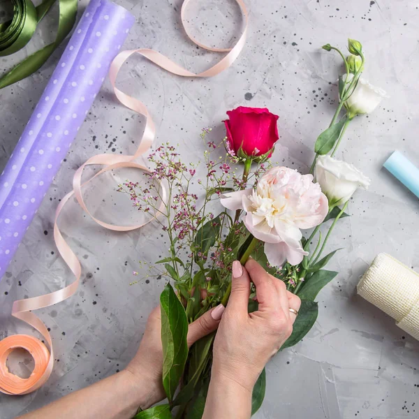 Ferramentas de florista e local de trabalho com fitas, flores e tesouras — Fotografia de Stock