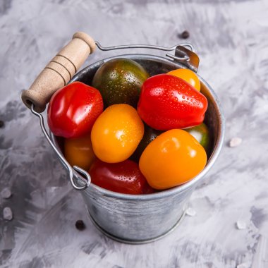 Gri bir arka plan üzerinde sebze yemek pişirmek için olgun domates