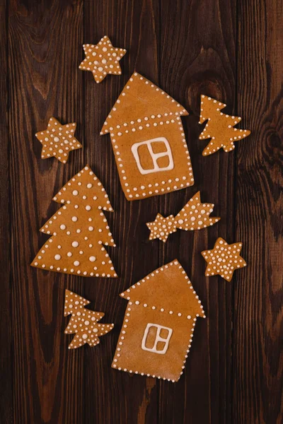 Different shapes of gingerbread cookies on wooden table. New year — Stock Photo, Image
