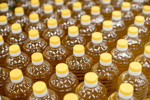 Soft focus to the Bottle Caps. Caps of yellow bottles with sunflower oil