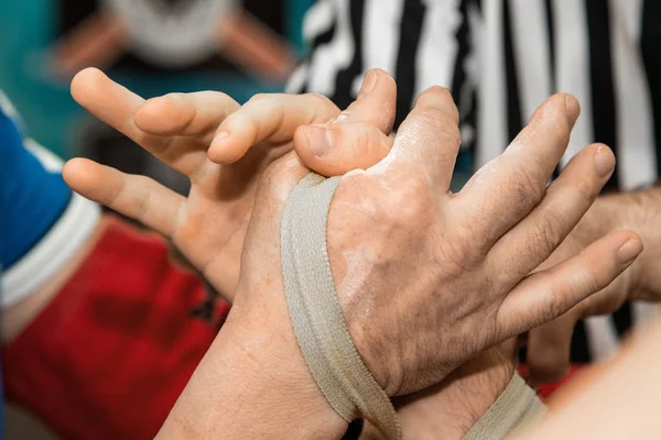 Two men in arm wrestling. sports competition. Two muscular arms. Rivalry and comparison of forces.