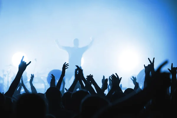 Sahnede güzel ışıklandırması olan rock grubu müzisyenlerinin bulanık siluetleri.