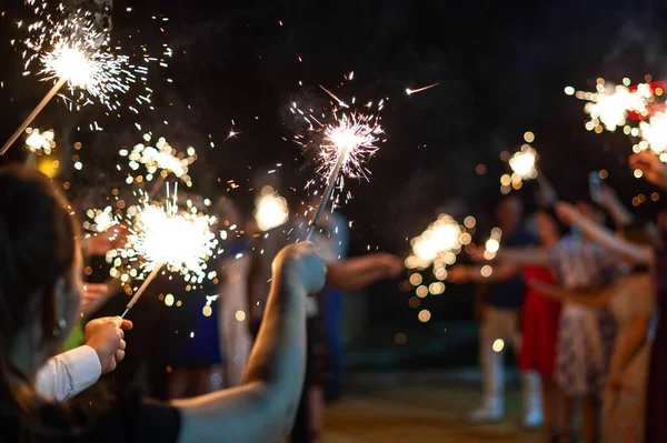 Festive Burning Bright Sparklers Hands Guests Party New Year Wedding — Stock Photo, Image