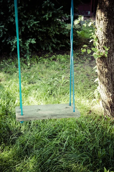 Old wooden swing in a garden