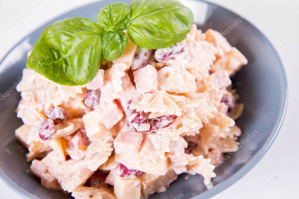 Pasta salad with cheese, ham, kidney beans and mayonnaise