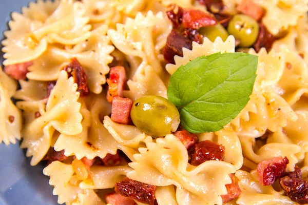 Farfalle Pasta Sun Dried Tomato Ham Olives Decorated Fresh Mint — Stock Photo, Image