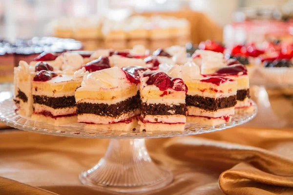 Selection of cakes and pastry set up on cake stands for a party