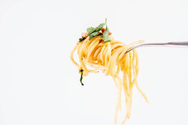 Spagetti Carbonara bazı maydanoz üzerinde beyaz bir arka plan üzerinde bir çatalı ile