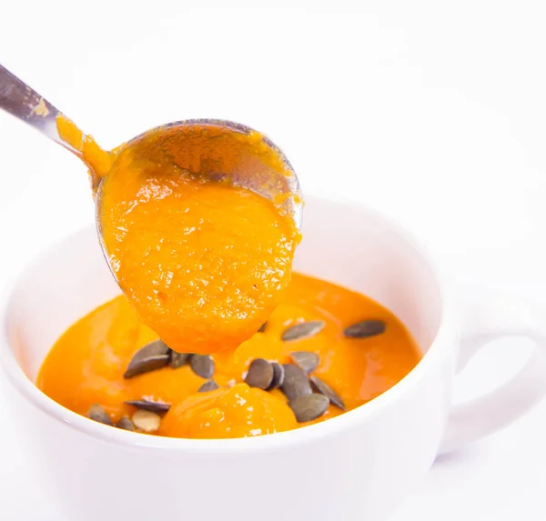 Pumpkin Soup Decorated Pumpkin Seeds Being Poured Bowl Wooden Background — Stock Photo, Image