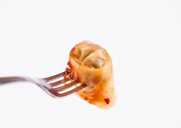 Chinese Traditional Spring roll with sweet and sour sauce eaten with a fork