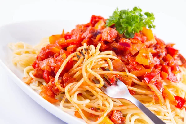 Spaghetti with sauce decorated with parsley eaten with a fork on a white background