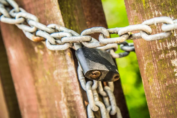 Stock image Wooden gate closed with a padlock 