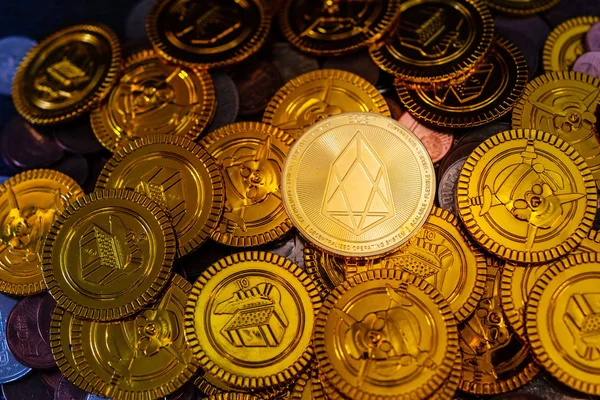 Golden EOS.IO and mound of money. Digital cryptocurrency concept
