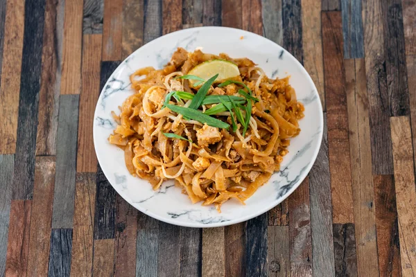Pad Thai, vegan recipe made with rice noodles, vegetables and peanuts cooked on wo