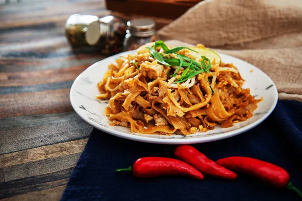 Pad Thai, vegan recipe made with rice noodles, vegetables and peanuts cooked on wok