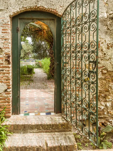 Arab garden behind a wrought iron metal portal