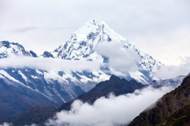 Mount Salkantay in the middle of clouds clipart