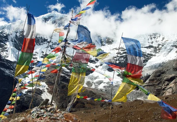 Buddhist prayer flags and Peak 7 VII, Nepal Himalayas