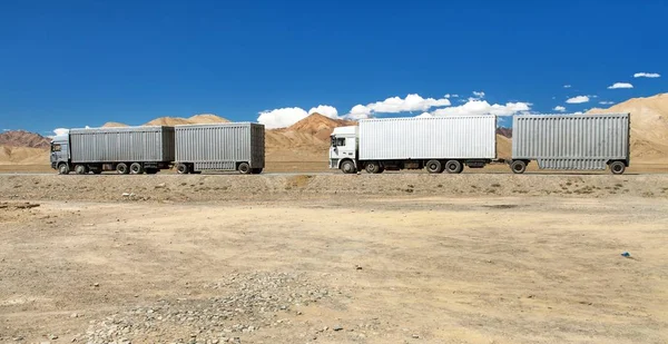 Pamir highway or pamirskij trakt and white truck