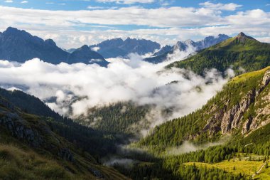 Dolomites mountains in the middle of Clouds, Carnian Alps mountains, Italy