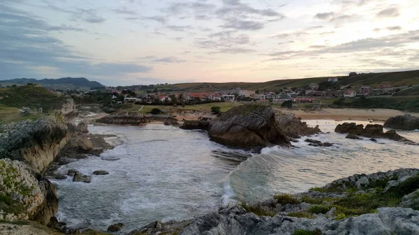 tidal wave in the mouth the river at sunset. Soto de la Marina, Cantabria, North Spain