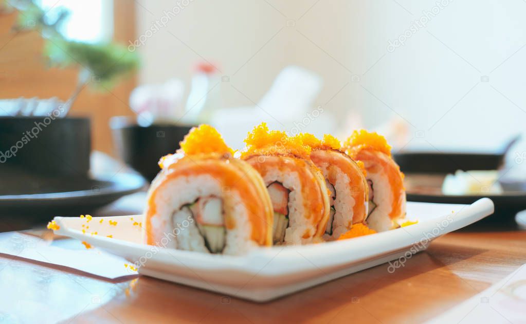 Selective focus four piece of philadelphia rolls with tobiko on top. Japanese food meal