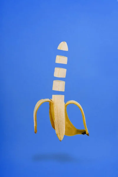 Banana Slice Isolated Flying on Blue Background