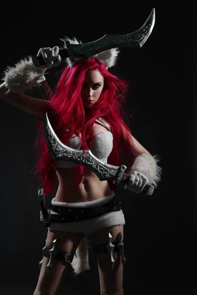 性感的红发女人在战士猫的姿势服装与剑在黑暗的背景摆姿势 — 图库照片