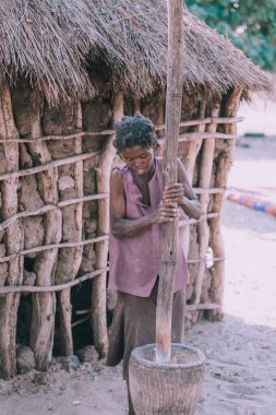 Namibya, Mbeyo, 12 Mayıs: harç town Rundu yakınındaki darı kırma kimliği belirsiz kirli ve yoksul bir kadın. Kavango, Namibia en yüksek yoksulluk düzeyi bölgesidir. 12 Mayıs 2018, Namibya