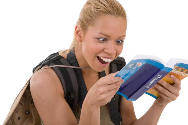 Pretty Blond Girl Reading Her Guidebook Looking Surprised — Stock Photo, Image