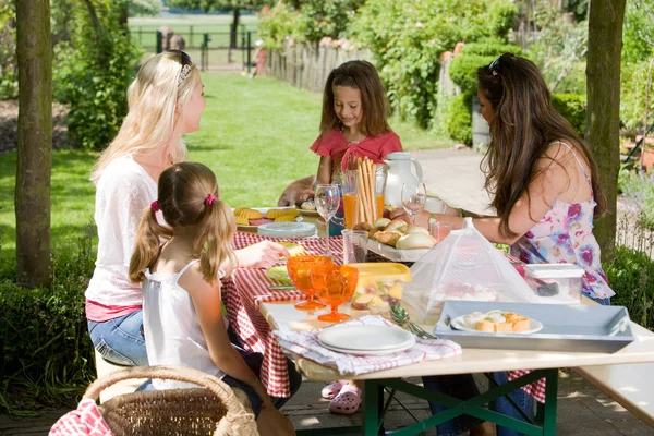 妇女和她们的女儿在餐桌边吃午饭 — 图库照片