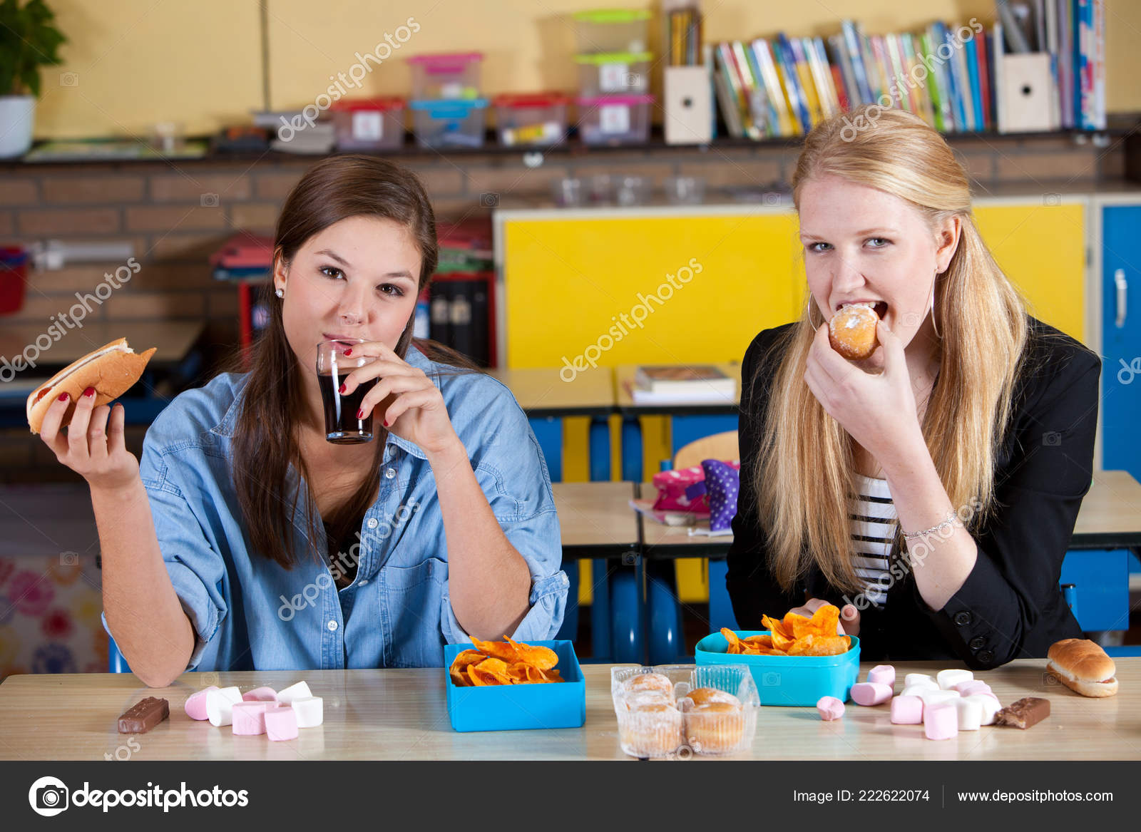 Two Schoolgirls Eating Unhealthy Lunch Desks Stock Photo by ©Fotosmurf