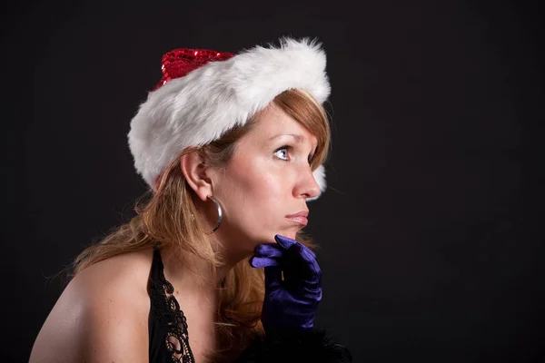 Pretty Blond Girl Wearing Christmas Hat Being Clearly Bored Stock Picture