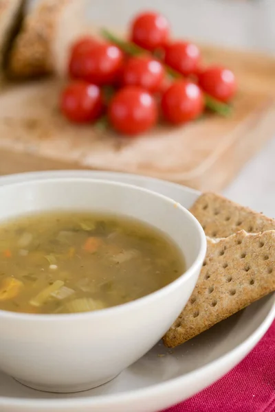 Delicious bowl of vegetable soup with crackers